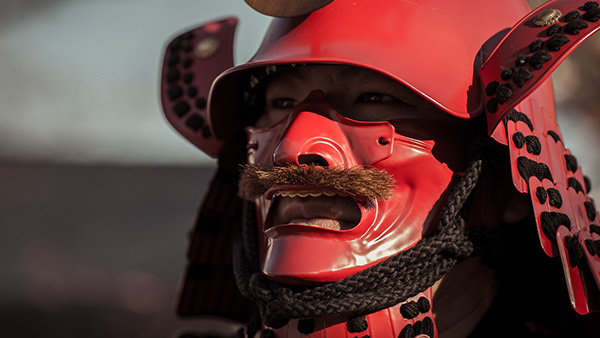 Red theatrical mask with an expressive face
