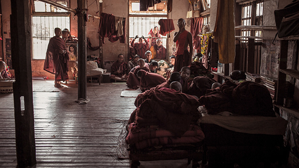 People resting beside columns inside a temple