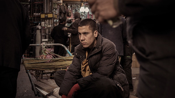 Lost in the moment while taking a break from cart hauling in the bazaar. Tehran, Iran