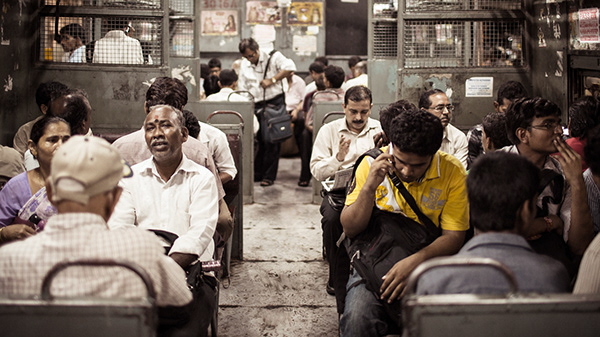 People seated in a crowded marketplace