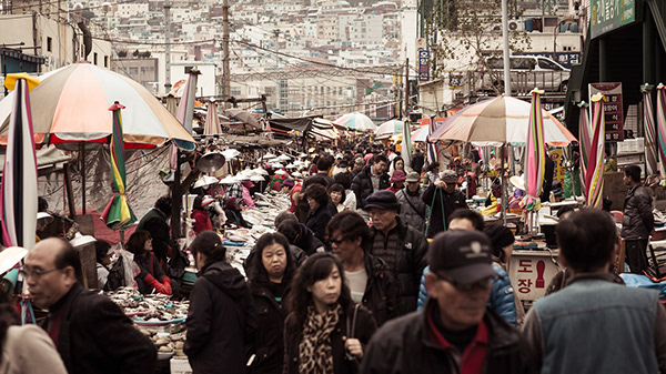 Crowded street market filled with pedestrians and stalls