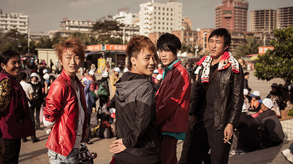 Group of young people walking through a busy public square