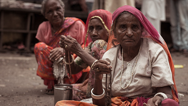 Women in colorful head coverings seated at a market