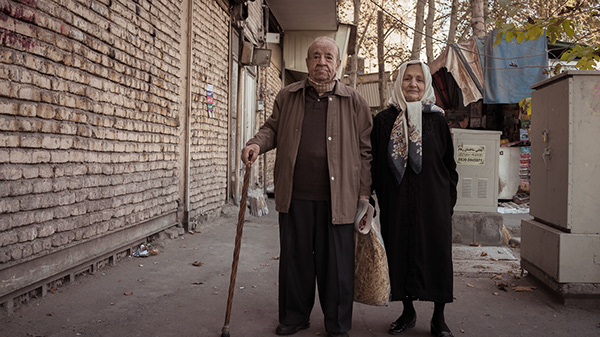 Two people standing together in a narrow alley