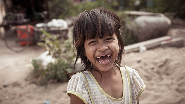 Young child laughing outdoors