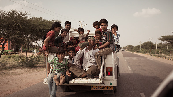 People traveling in an overloaded pickup in Rajasthan. Bikaner, India