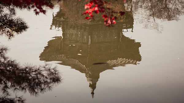 Reflection of a pavilion in still water